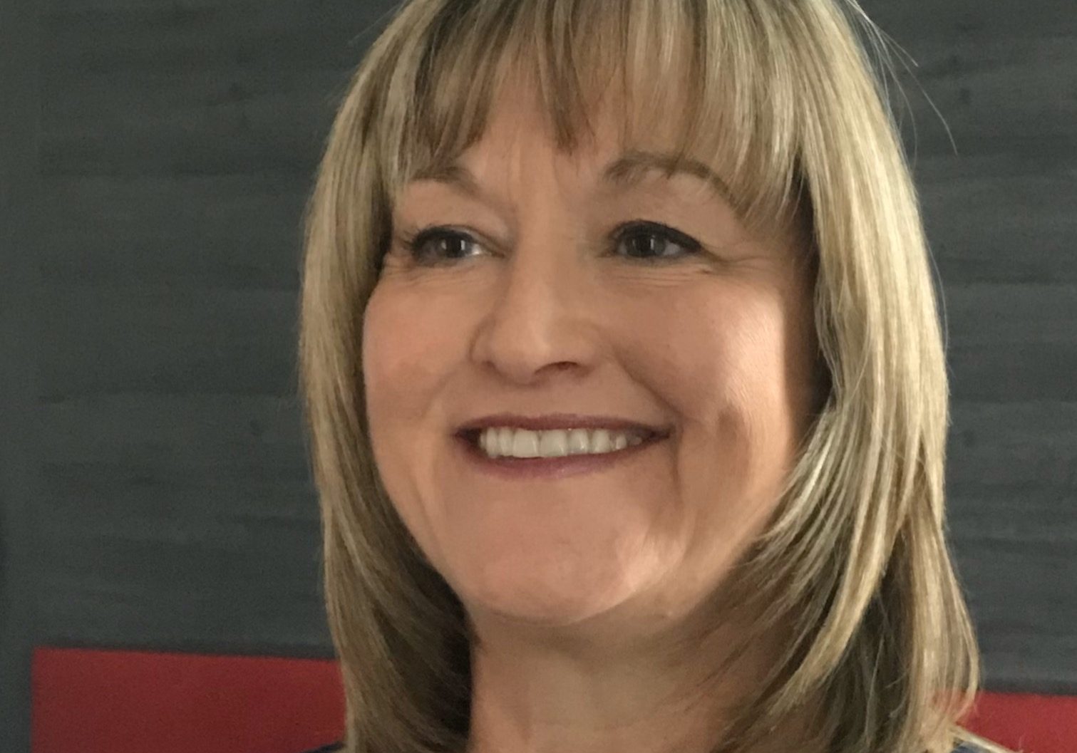 Photo of white lady with shoulder length golden hair including a fringe
