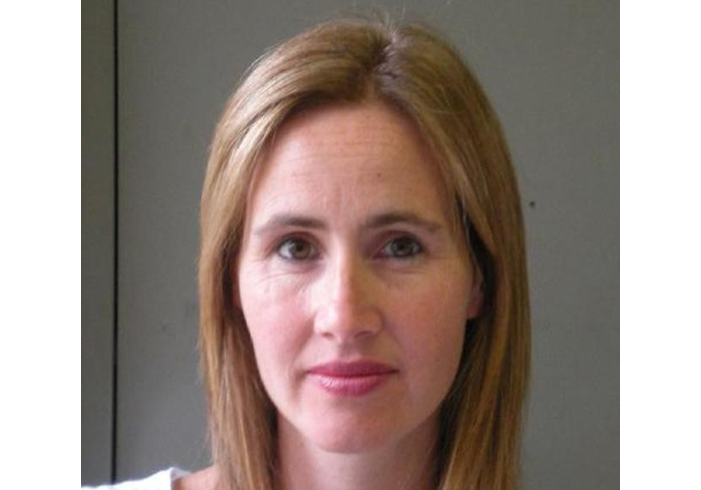 Photo of a white woman with shoulder length light hair