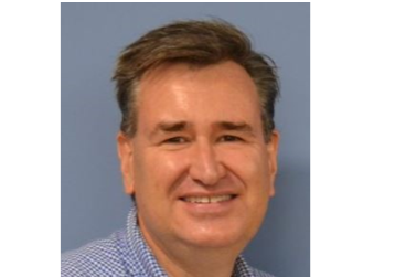 Headshot photo of a white male with dark short hair